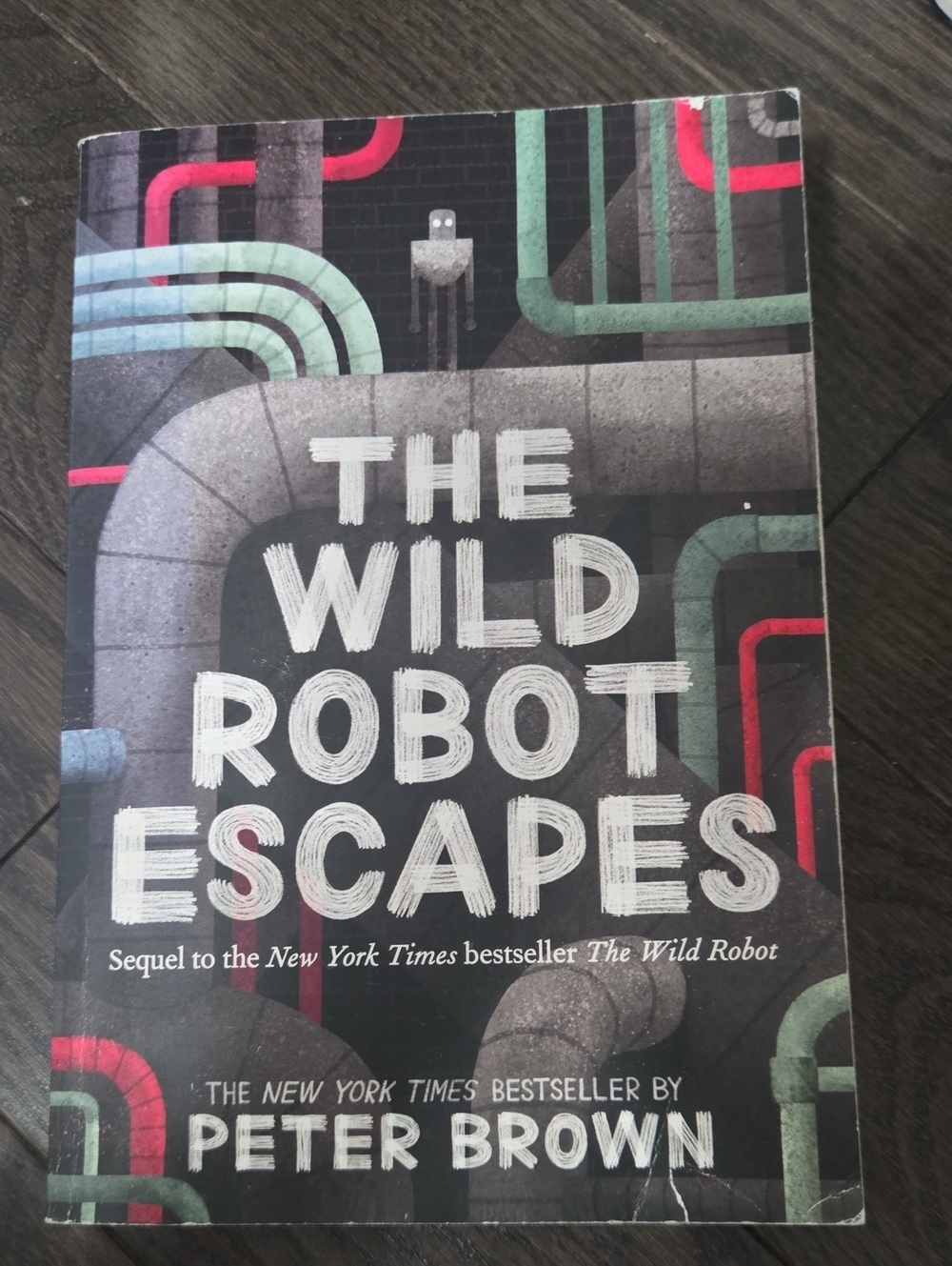 The Wild Robot Escapes by Peter Brown - Black Cover with Red & Green Accents